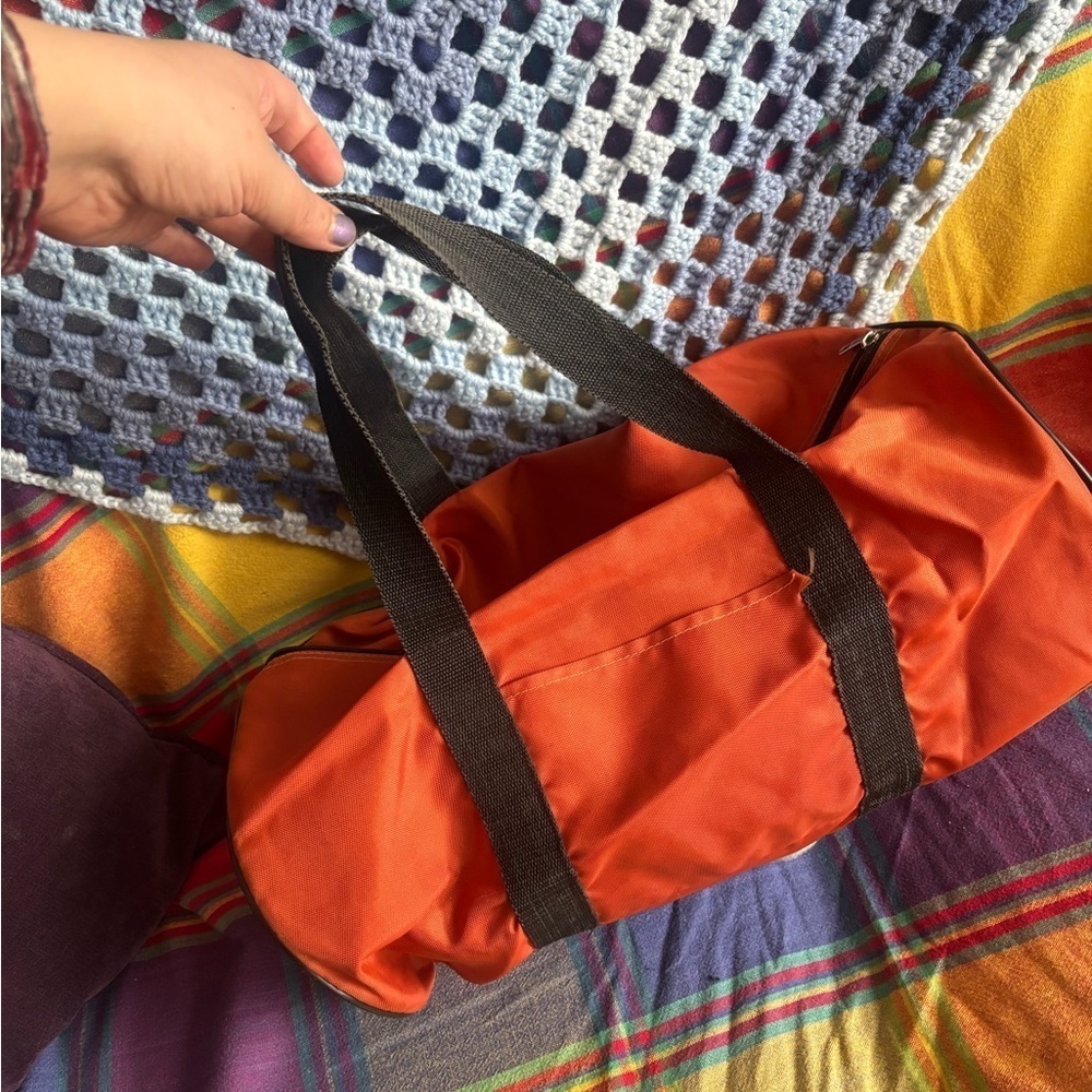 Bright Orange Duffel Bag with Black Handlesโ